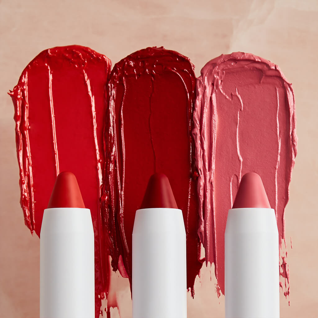 Three tubes of lipstick lined up before their color swatches.